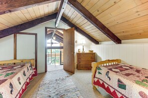 A bedroom with two beds, a dresser, and a window. - White Mtn Views & Game Room in Edelweiss Village (Madison)