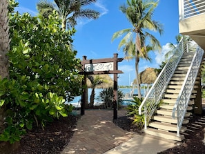 A pathway leading to a building with a staircase on the right. - Kokomo Keys - Waterfront Heated Pool (Summerland Key)