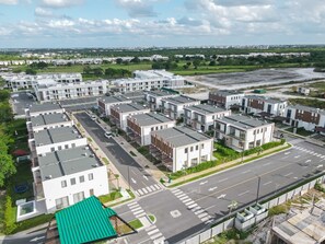 A residential area with modern apartment buildings, wide streets, and green spaces. - NOK Contemporary Retreat in Ziba Punta Cana (Punta Cana)