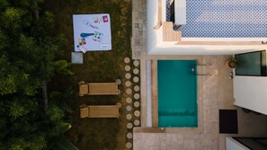 An aerial view of a property with a swimming pool, two lounge chairs, and a table with various items. - La Vida Retreat - Luxe 2 Bed Villa in Jaipur (Jaipur)