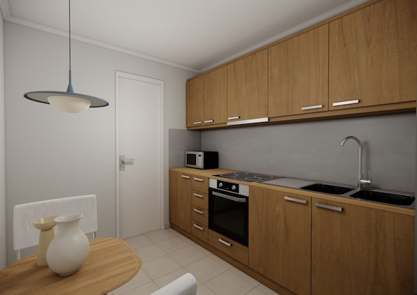 Una cocina compacta con armarios de madera, microondas, estufa y lavamanos.