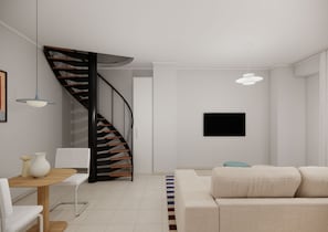 Una sala de estar moderna con una escalera, un comedor y un televisor de pantalla plana montado en la pared.