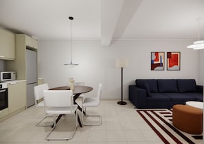 Una sala de estar moderna con comedor, un sofá, una lámpara y arte abstracto en la pared.