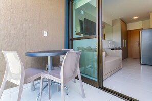 Um interior moderno com área de jantar, sofá e cozinha.