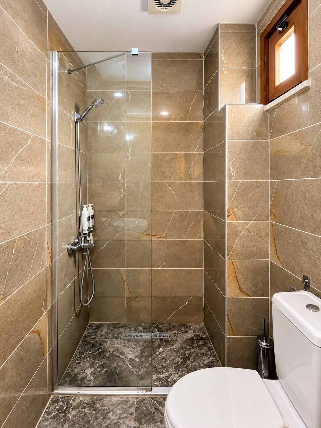 Un baño moderno con ducha de vidrio, inodoro y lavamanos.