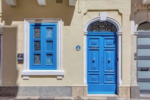 Ein Gebäude mit blauer Tür und Fenster, einem Briefkasten und einem Schild mit der Nummer 360.