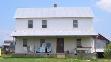 A two-story white house with a front porch and a visible garage.