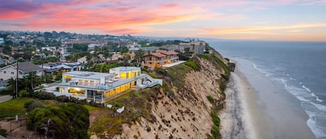 A coastal residential area with houses overlooking the beach.