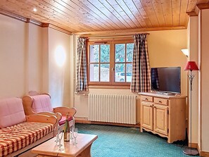 A cozy room with a bed, a table with glasses, a TV, and a window with curtains. - 3-room apartment at the foot of slopes, terrace, 6 pers (Les Deux Alpes)