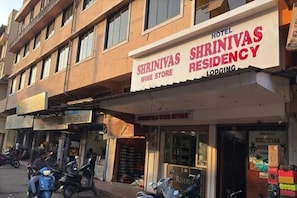 A hotel named 'SHRINIVAS' with a wine store and lodging services.