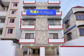 A multi-story building with a sign for 'fabHOTELS' indicating a hotel establishment. - FabHotel Parinda Lodging (Pune)