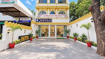 Ein Hotel Eingang mit einem Schild für 'Jharokha Palace' und 'Netaji' Hotel.
