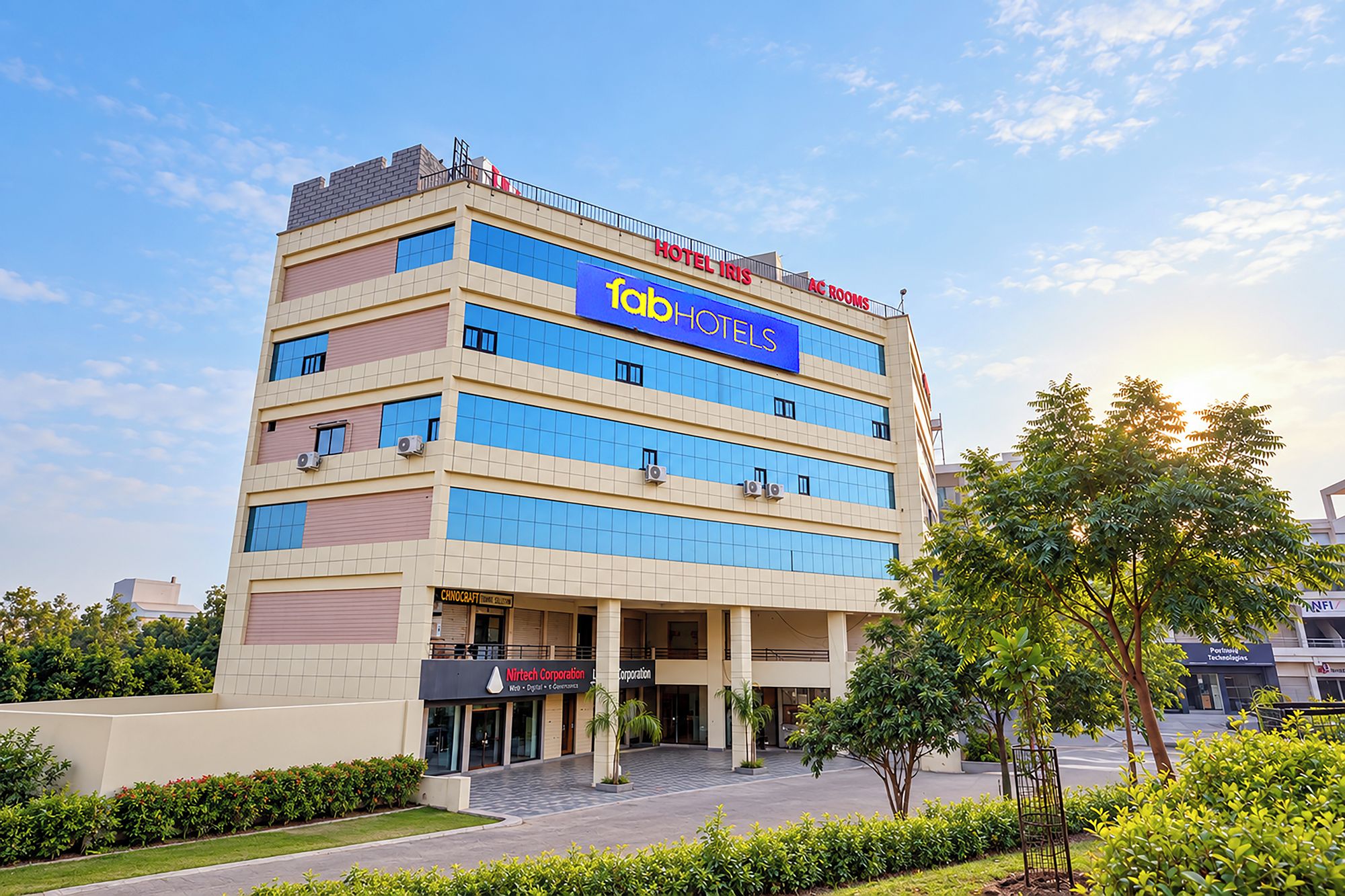 A multi-story hotel with a prominent 'HOTEL IRIS' sign, a 'Nirtech Corporation' sign, and a 'Portside Technologies' sign.