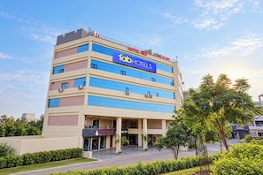 A multi-story hotel with a prominent 'HOTEL IRIS' sign, a 'Nirtech Corporation' sign, and a 'Portside Technologies' sign.