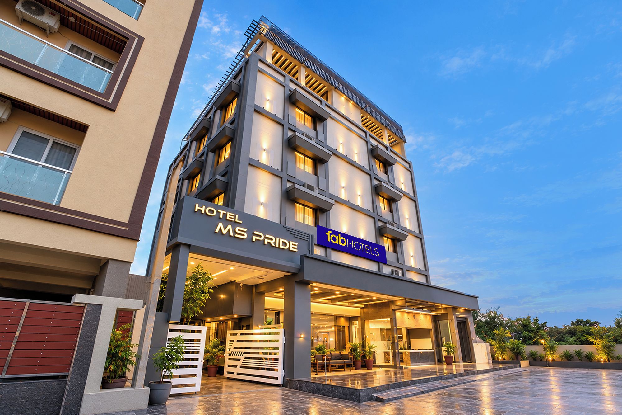 A multi-story hotel with a modern facade, a prominent entrance, and a well-lit lobby area.