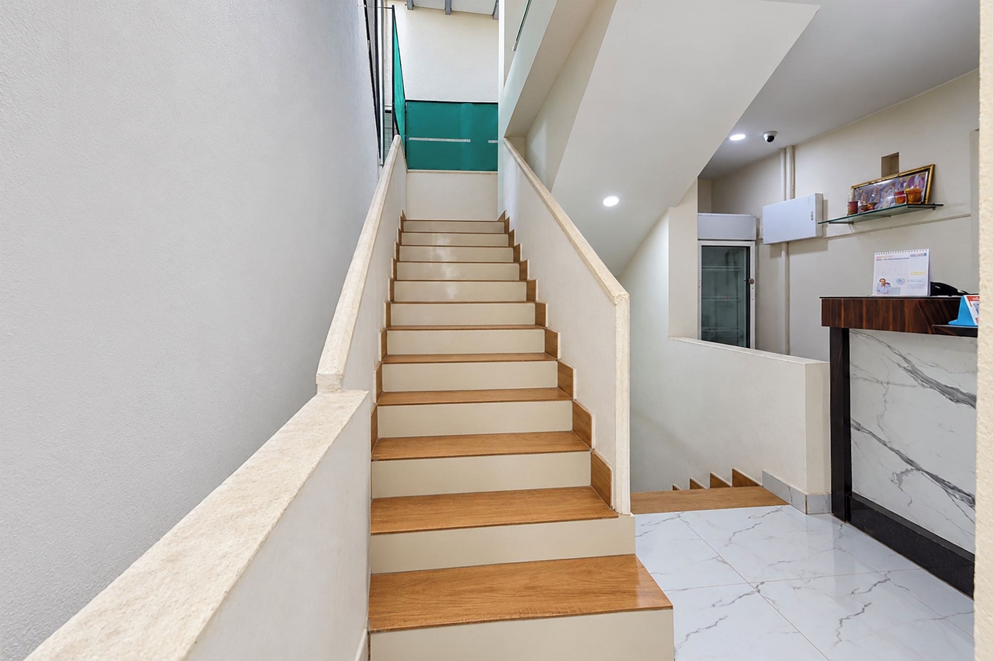 A staircase with wooden steps leading to a landing.