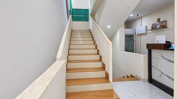 A staircase with wooden steps leading to a landing.