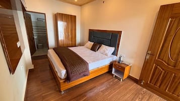 A bedroom with a wooden bed, a nightstand, and a wardrobe.