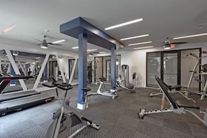 A gym with various exercise equipment, including treadmills, elliptical machines, and weight benches. - Modern Midtown, Minutes to Broadway, Parking, Pool (Nashville)