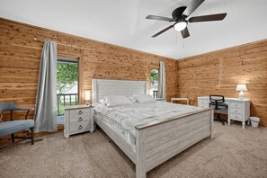 A bedroom with a bed, a desk, a chair, a nightstand, a ceiling fan, and a window with curtains. - Lake Cumberland Views, Hot Tub & Room for 11 (Somerset)