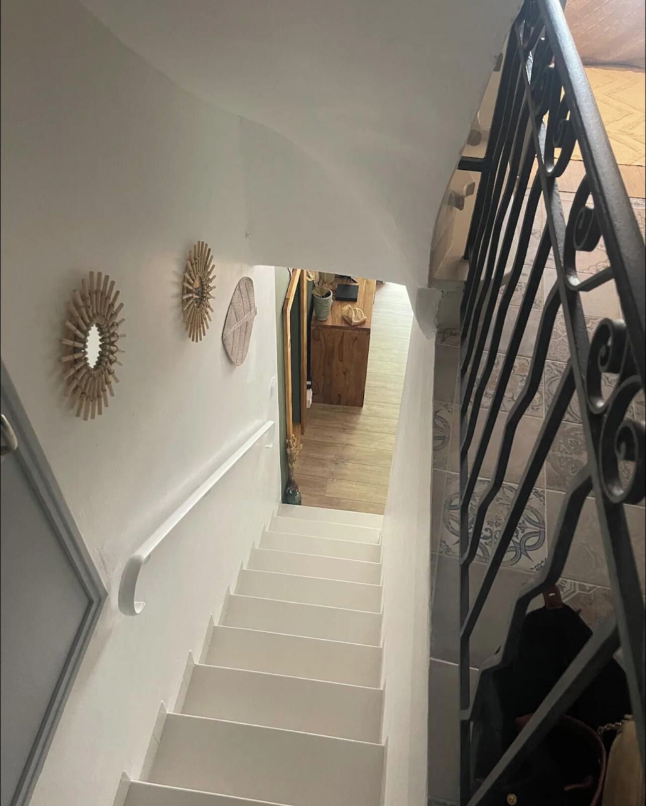 A staircase with white steps leading to a landing.