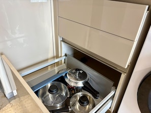 A kitchen with a built-in stove and a service cabinet.