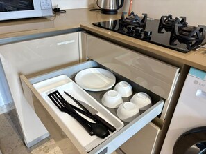 A kitchen with a built-in microwave, stove, and dishwasher.