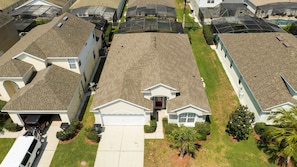 A residential area with houses featuring pitched roofs and a central driveway. - 4BR Windsor Palms Pool, spa & Mickey Room (Kissimmee)