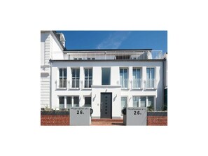 A two-story building with a flat facade, numbered 26A and 26B, featuring a central entrance and balconies. - Seilerstr./knyphausenstr.26b - Elenchen (Norderney)