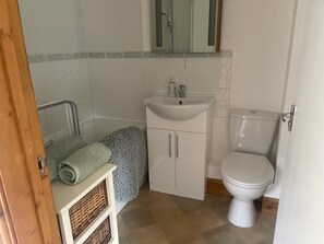 Ein Badezimmer mit Toilette, Waschbecken und Dusche.
