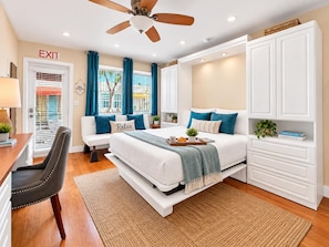 A bedroom with a bed, a desk, a chair, a wardrobe, and a ceiling fan. - Steps to the Beach in Hollywood (Hollywood)
