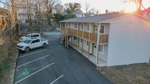 A two-story building with a wooden deck and a covered parking area. - Stay Roanoke | Cozy 1BR Near Hospital, Downtown (Roanoke)