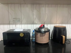 A kitchen counter with a coffee maker, a rice cooker, and a toaster. - Delightful 2-bedrooms apartment with AC in Dar es Salaam (Dar es Salaam)