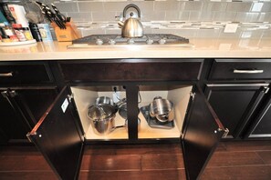 A kitchen with a built-in drawer containing pots and pans. - Katy Retreat - 5 Bed -Pergola- 5 min to Katy Mills (Katy)