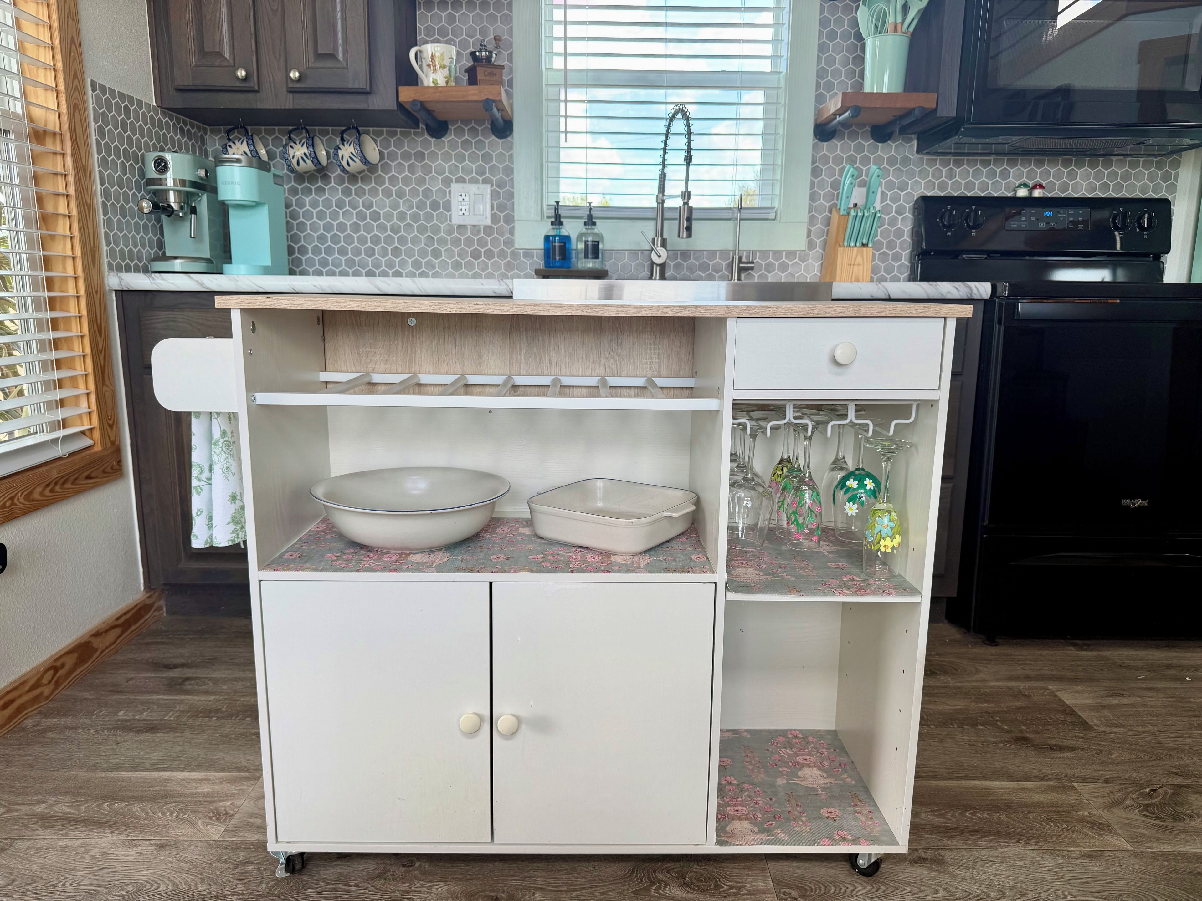 A kitchen with a built-in white cabinet, a coffee maker, and a microwave.