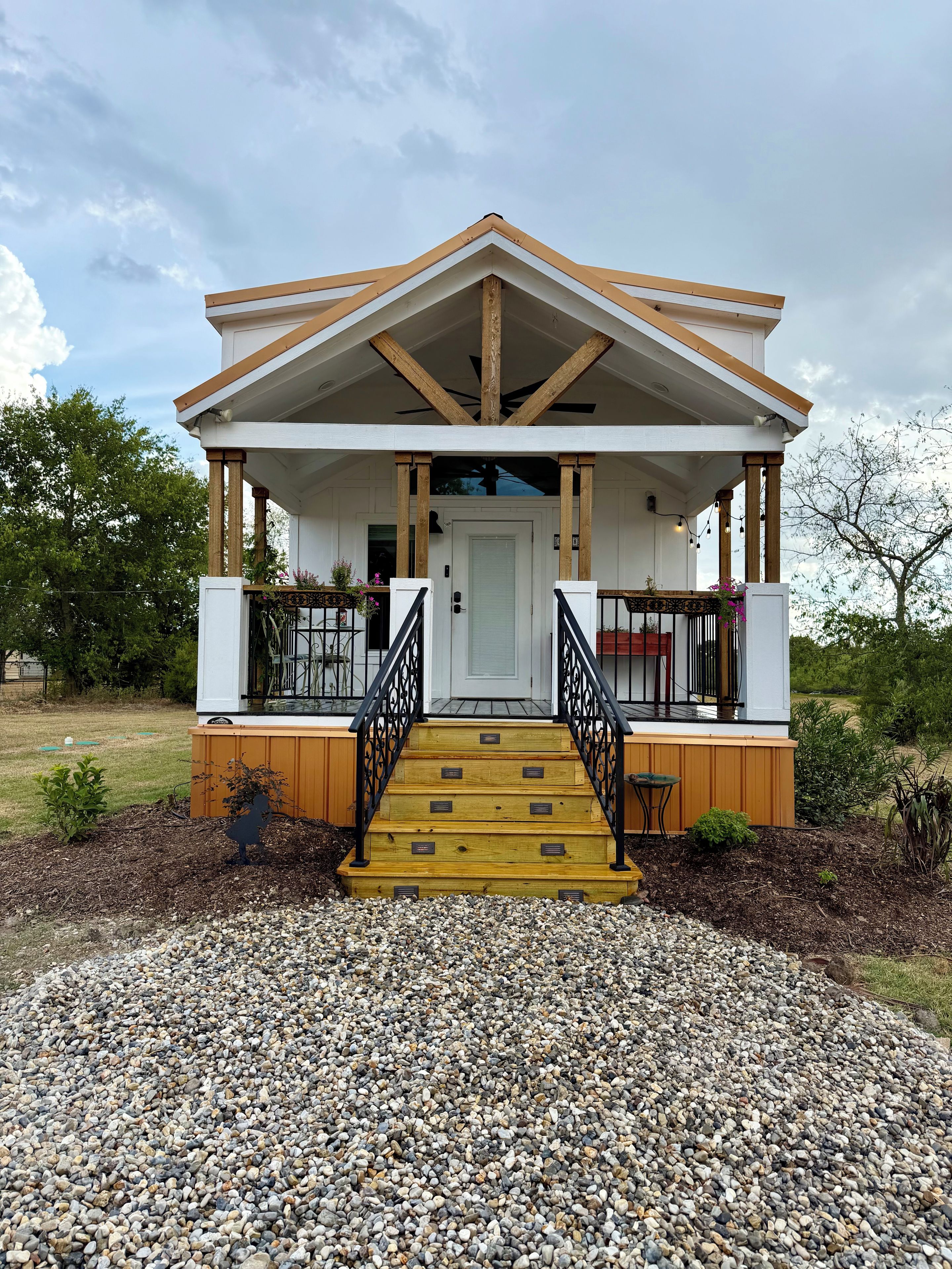 A building with a porch, wooden steps, and a door.