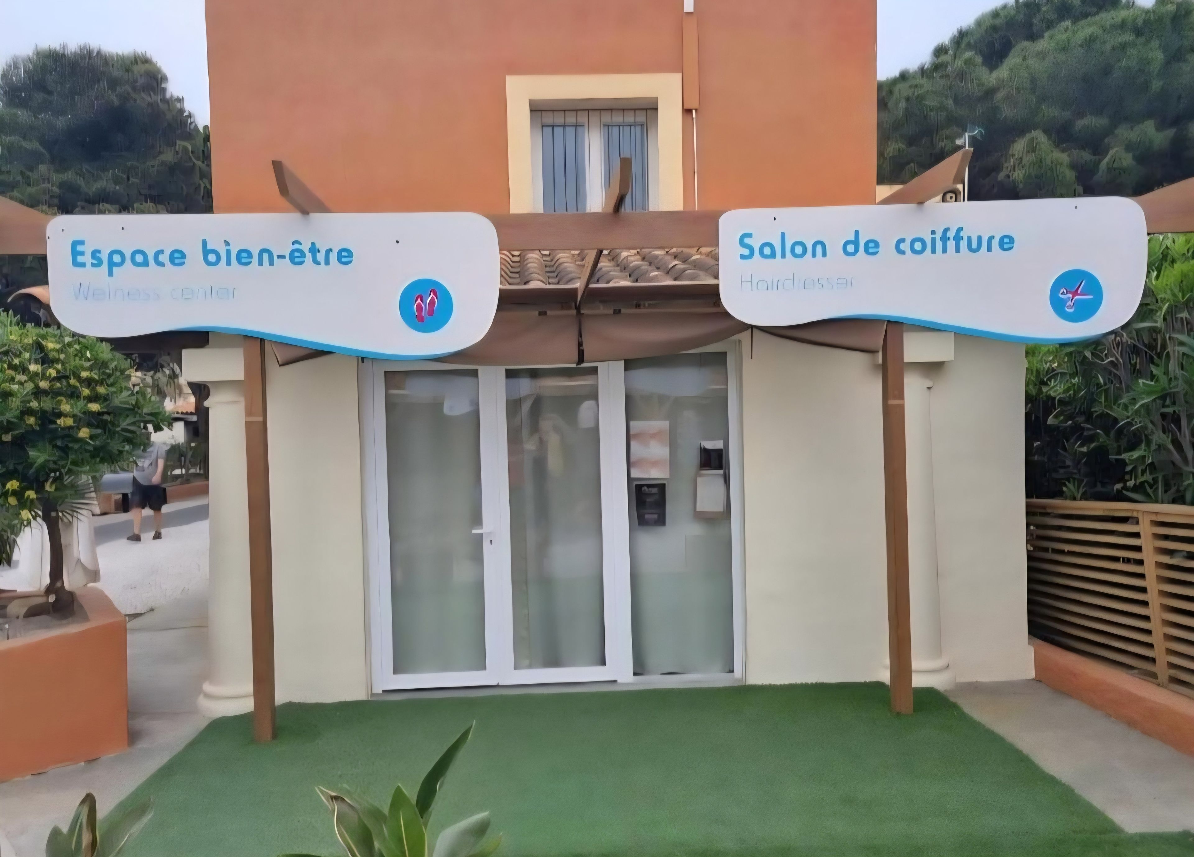 A wellness center and a hairdresser salon with signage.