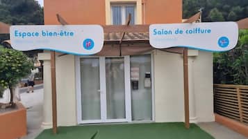 A wellness center and a hairdresser salon with signage.