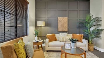 A living room with a sofa, coffee table, and decorative items.
