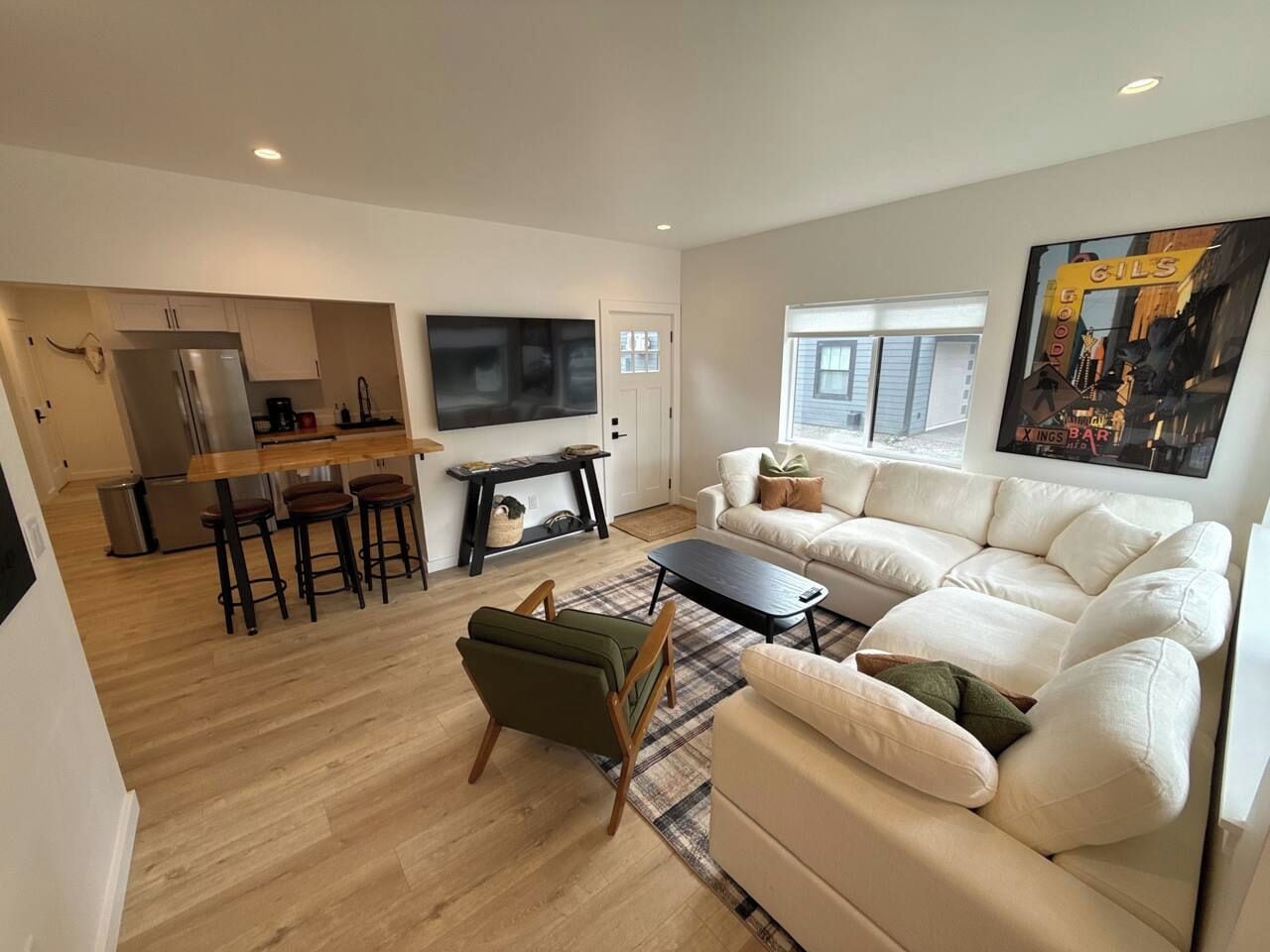 A modern living room with a sofa, a coffee table, and a TV.