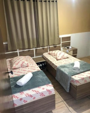 A hotel room with two beds, a nightstand, and a window with curtains. - Hotel Itaquera Inn  (Sao Paulo)