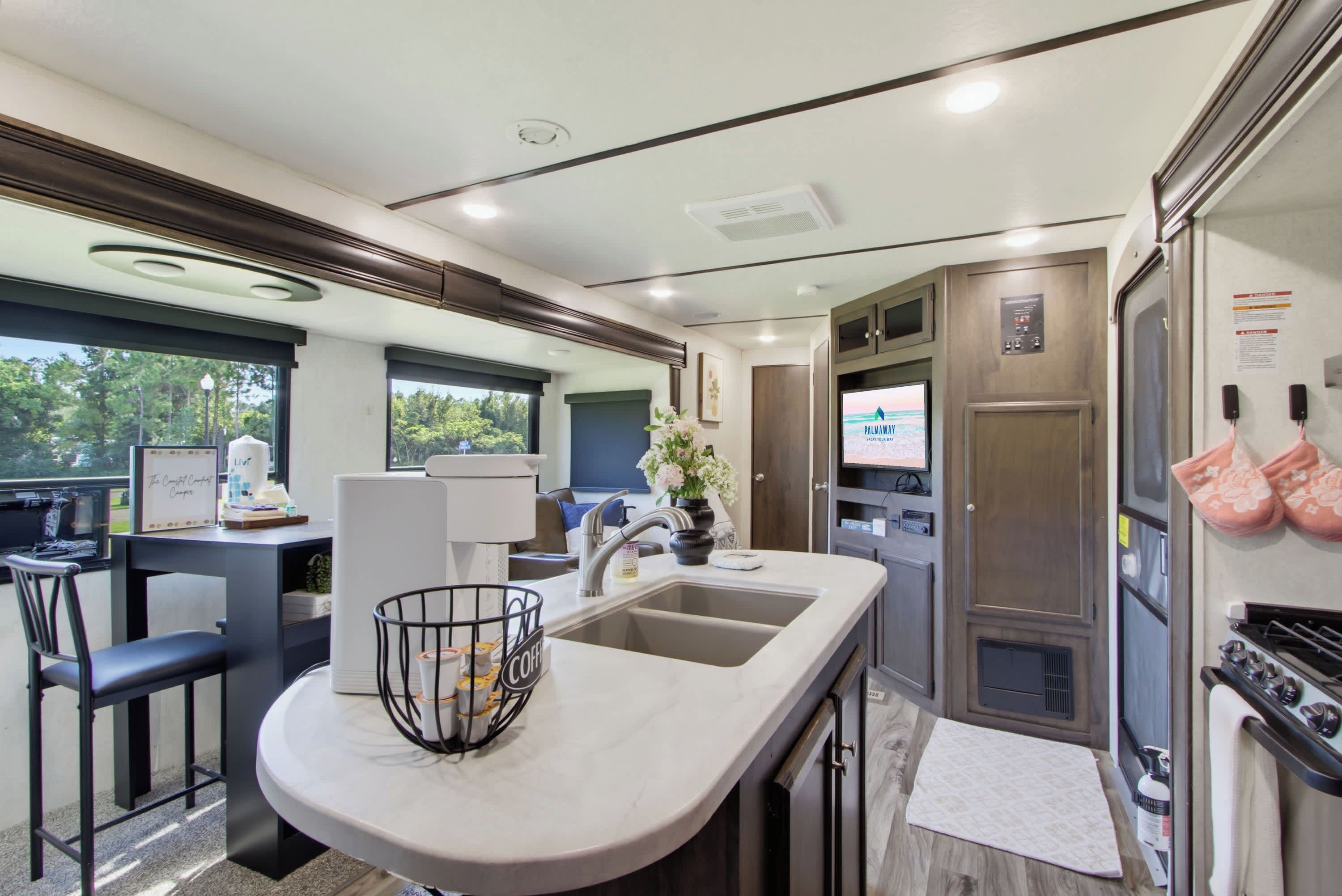 A modern kitchen with a bar area, a sink, and a stove.