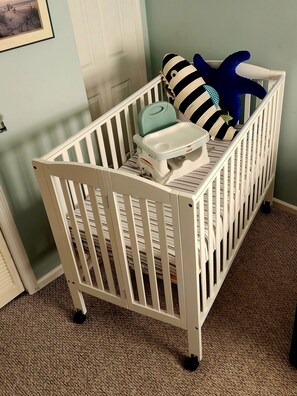 A white crib with a changing table and a blue toy. - 3-bedroom two-story enchanted condo in terrific St. Simons Island (St. Simons Island)