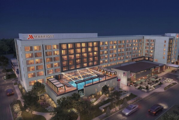 A Marriott hotel with multiple floors, a rooftop pool, and a landscaped courtyard.