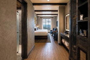 A hotel room with a large bed, a desk with a chair, a large window with a mountain view, and a bathroom with a shower and toilet. - The Scoundrel Hotel, Downtown Gatlinburg, A Tribute Portfolio Hotel (Gatlinburg)