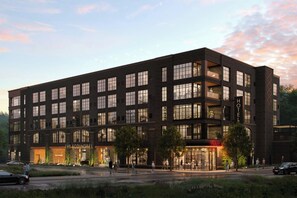 A modern hotel with multiple floors, large windows, and a ground-level bar. - The Scoundrel Hotel, Downtown Gatlinburg, A Tribute Portfolio Hotel (Gatlinburg)