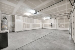 Ein großzügiger Innenraum mit Betonboden, weißen Wänden und einer Tür.