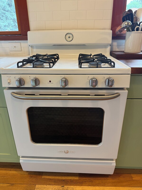 A white electric stove with four burners and a front oven door.