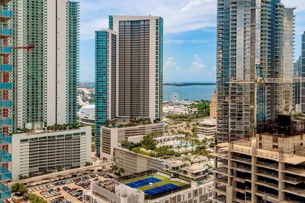 A high-rise building with multiple floors, a parking area, and a view of the sea. - E11EVEN Skyline Studio | 33rd Floor City Views (Miami)