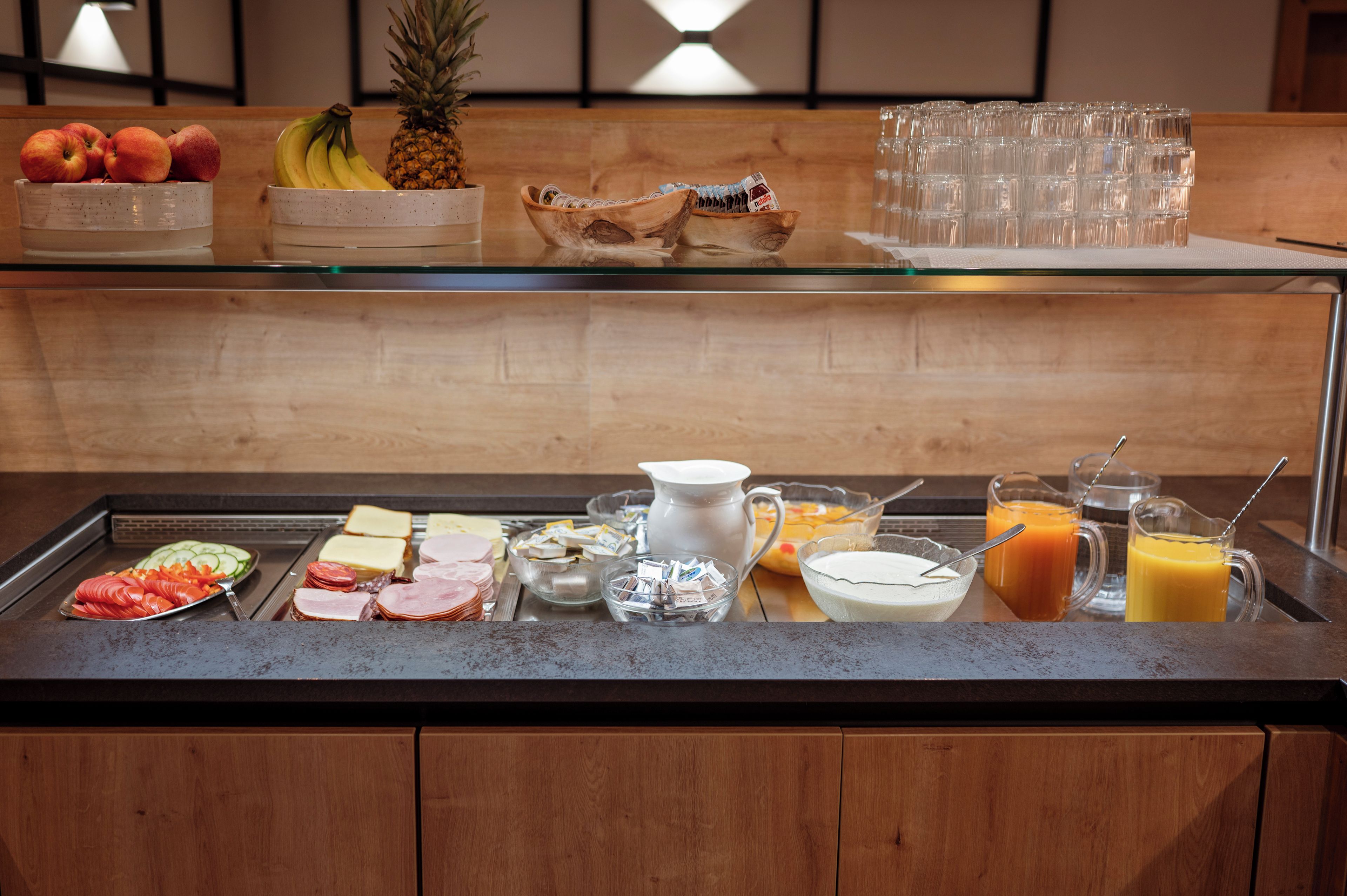 A buffet with various food items and beverages.
